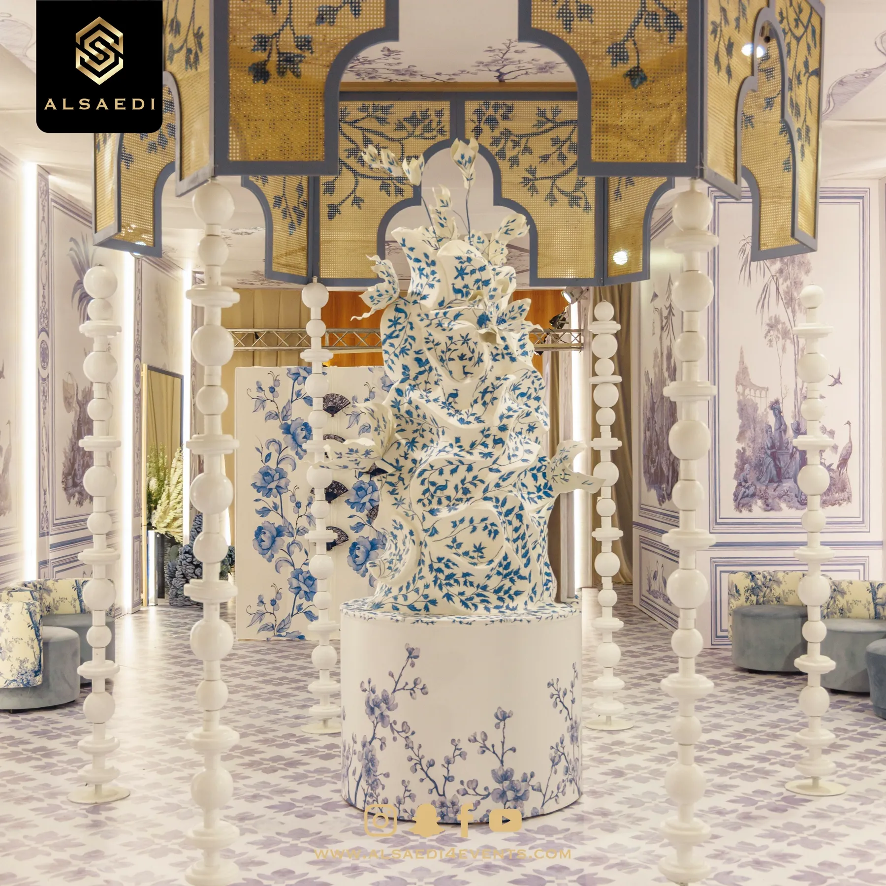 Wedding cake under a gilded arch